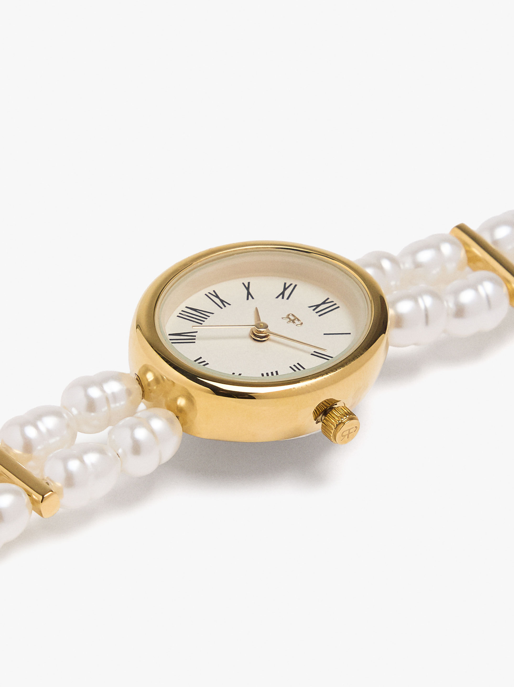 Reloj con múltiples pulseras de perlas